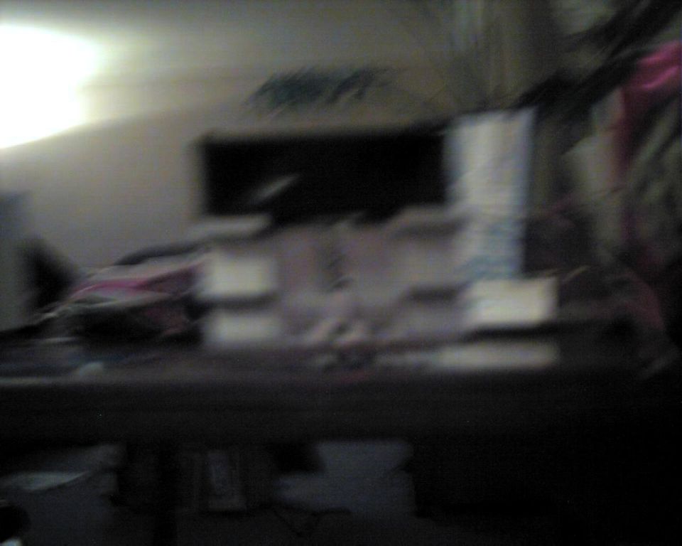 Interior scene with objects on a table, Supermotors.net logo visible