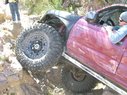 1986 Toyota Hilux - This modified Toyota Tacoma is navigating a difficult rocky trail.