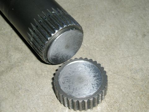 1986 Toyota Hilux - A close-up shows a splined shaft and a gear, likely automotive parts, on a concrete surface.