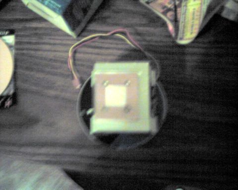 1990 Ford Taurus - A computer CPU cooler is shown on a wooden surface, with wires attached.