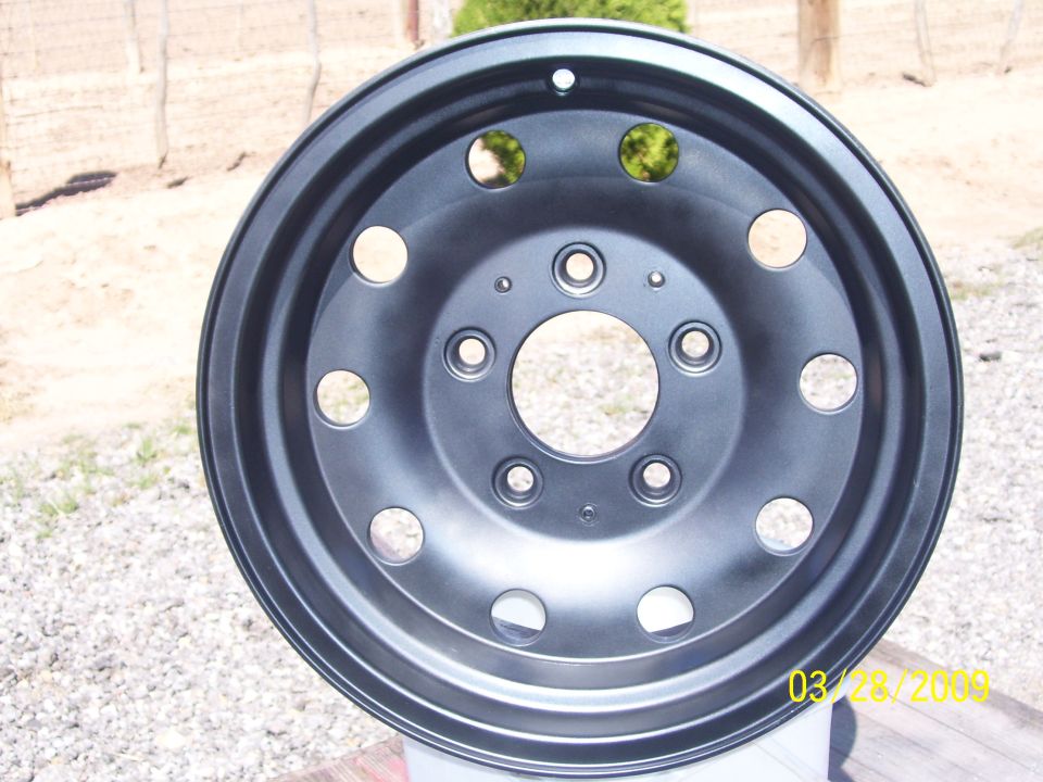 Black painted wheel with multiple lug nut holes
