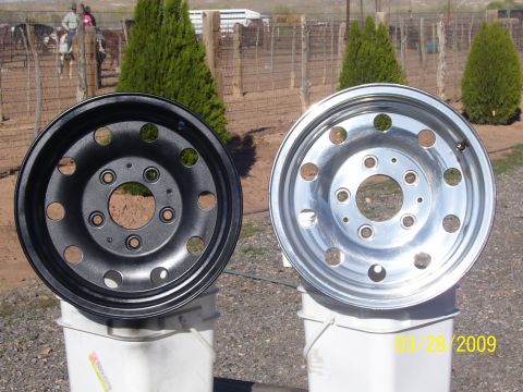 1993 Ford Bronco - A black wheel and a polished aluminum wheel are displayed side-by-side on buckets.