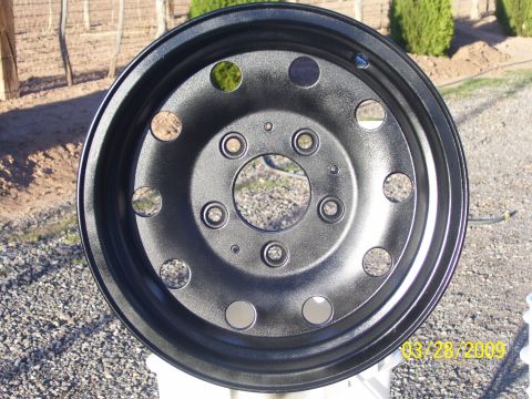 1993 Ford Bronco - A freshly painted black wheel is shown, likely after a refurbishment or customization.