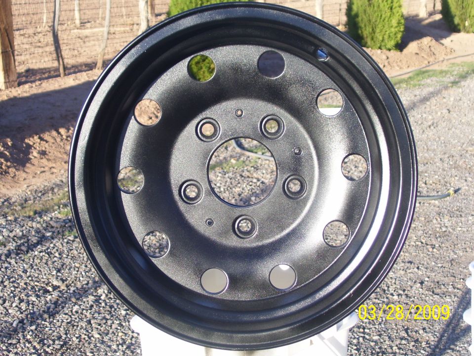 Black painted wheel with multiple lug nut holes