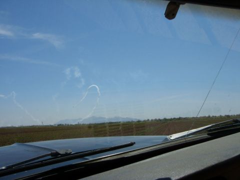 1978 Ford Bronco - Contrails from an airshow form patterns in the sky above distant mountains.