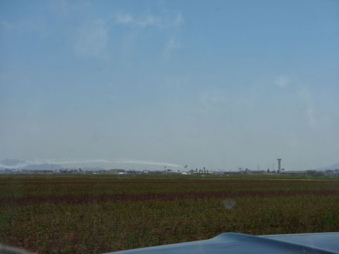 1978 Ford Bronco - An airport scene with planes in the air and a control tower visible in the distance.