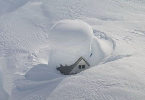 1974 Ford Ranchero - A house is nearly buried under a massive amount of snow.