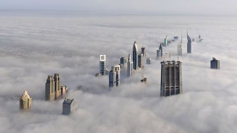 1974 Ford Ranchero - A dense fog blankets a city, leaving only the tops of skyscrapers visible.