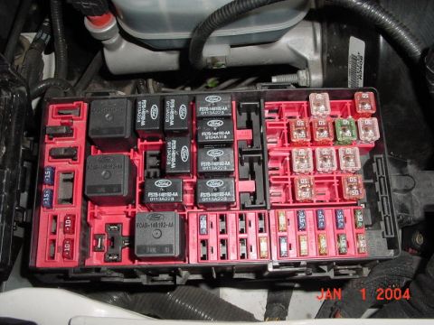 2007 Ford Mustang - Fuse box with Ford-labeled relays and assorted fuses visible. Date stamp reads JAN 1 2004.