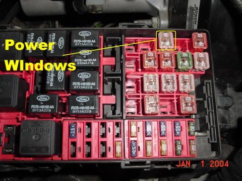 2007 Ford Mustang - A close-up view of a vehicle's fuse box, showing relays and fuses, with a label indicating 'Power Windows'.