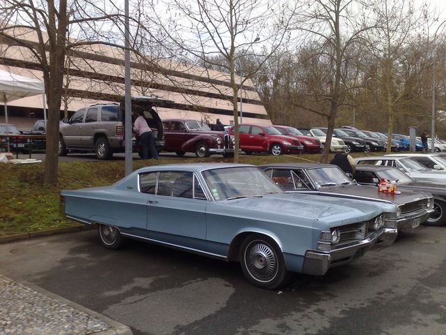 Light blue 1967 Chrysler Imperial coupe, side view, parked in a lot with other cars