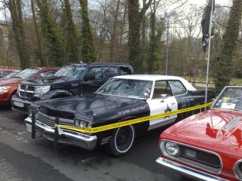 1991 Ford Crown Victoria - Police car marked with yellow tape, parked next to other vehicles.