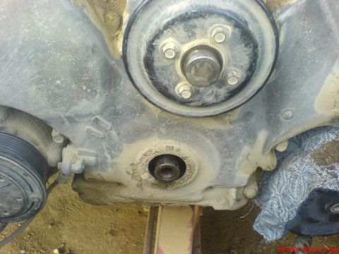 1992 Ford Crown Victoria - This is a close-up view of an engine's timing cover, showing pulleys and bolts.