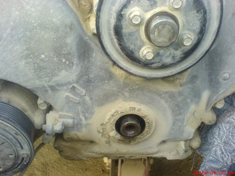 1992 Ford Crown Victoria - Close-up of an engine timing cover, showing pulleys and timing marks.