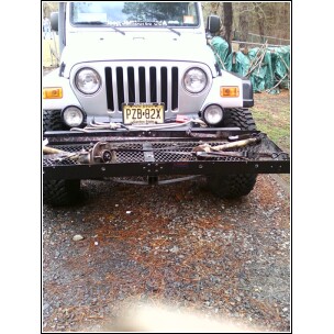 2004 Jeep Wrangler - A Jeep Wrangler is shown from the front, equipped with a trailer hitch and various items on it.