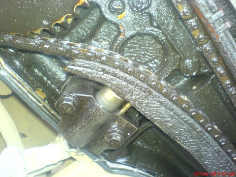 1992 Ford Crown Victoria - Close-up view of the timing chain and tensioner mechanism within an engine.