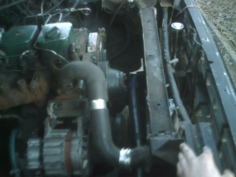 1989 Ford Bronco - Close-up view of a vehicle's engine bay, showing various components and hoses.