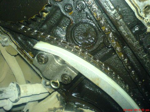 1992 Ford Crown Victoria - Close-up view of the timing chain and tensioner assembly within an engine.