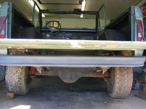 1992 Ford Mustang - Rear view of a green Ford Bronco, with its tailgate open and suspension components visible.