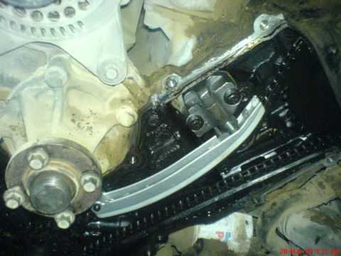 1992 Ford Crown Victoria - Close-up view of an engine's timing chain and tensioner mechanism.