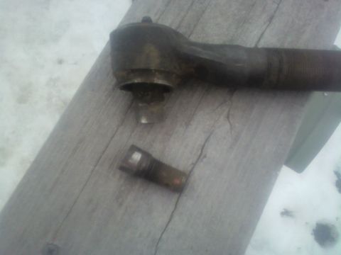1992 Ford F-350 - Tie rod end and stud, likely removed from a vehicle for repair or replacement.
