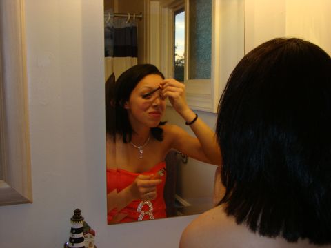 1989 Ford Bronco - A woman applies mascara while looking in a bathroom mirror.