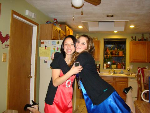 1989 Ford Bronco - Two friends share a hug in a kitchen setting, dressed up for an event.