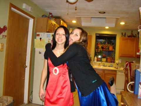 1989 Ford Bronco - Two young women pose for a photo in a kitchen, one wearing a red dress and the other a blue dress.