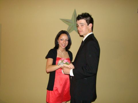 1989 Ford Bronco - A young couple poses for a photo at a prom event, with the girl in a red dress and the boy in a suit.