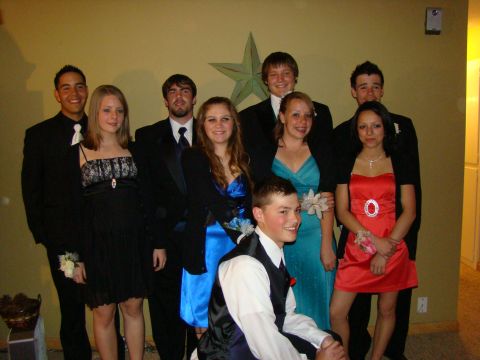 1989 Ford Bronco - A group of ten young adults dressed in formal attire for what appears to be a prom or special event.