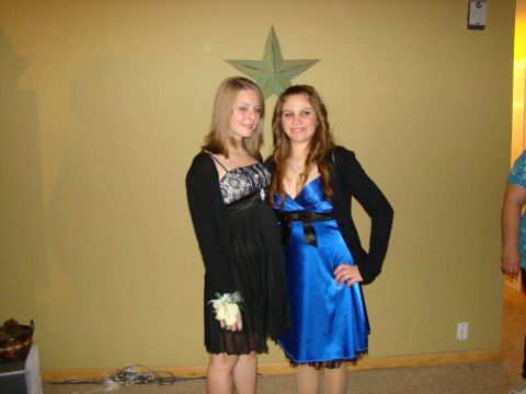 1989 Ford Bronco - Two young women pose for a photo in formal attire, possibly for a school dance or event.
