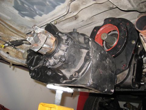 1991 Ford Bronco - Underside view of a vehicle's transfer case and driveline components.