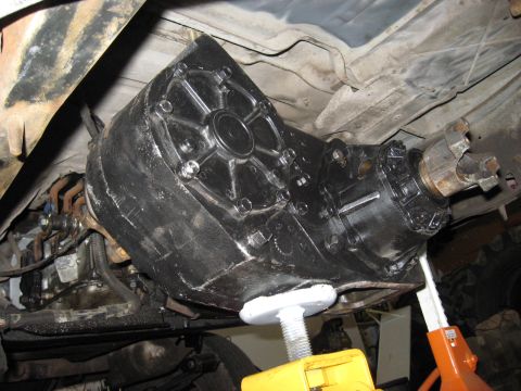 1991 Ford Bronco - Underside view of a vehicle's transfer case, showing mechanical components and support equipment.