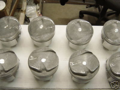 1972 Ford Ranchero - Several pistons are arranged in two rows on a workbench, with a watermark for SuperMotors.net at the bottom.