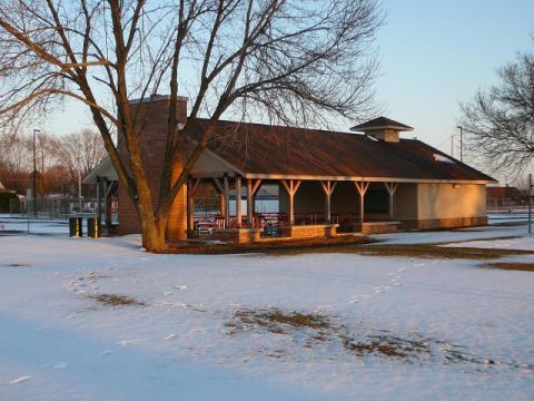 1997 Mercury Grand Marquis - A park pavilion stands in a snowy landscape, with a large tree partially obscuring the view.