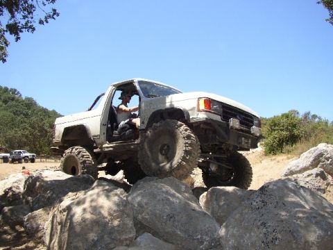 1989 Ford Bronco - Modified 1989 Ford Bronco tackling a rocky trail with extreme articulation.