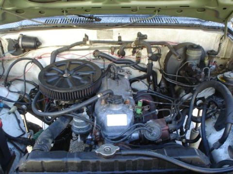 1990 Ford Bronco - Engine bay of a vehicle, showing various mechanical parts and wiring.