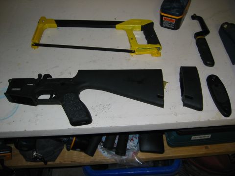 1996 Ford Bronco - Gun parts and tools are laid out on a workbench, suggesting a modification or assembly process.