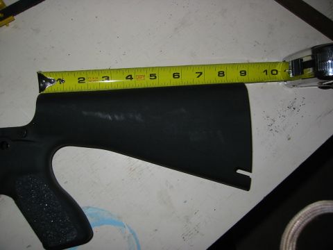 1996 Ford Bronco - Measuring a black part with a tape measure. The part extends from 2 to 10 inches on the tape.
