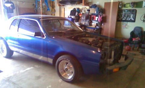 2006 Ford E350 - Blue coupe in garage with hood open and front bumper removed.