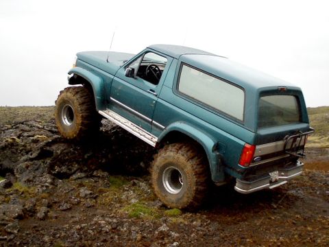 1996 Ford Bronco - This modified SUV navigates a challenging rocky landscape.
