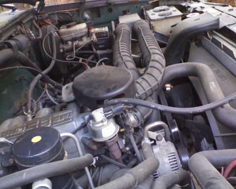1996 Ford Bronco - Close-up view of the engine compartment, showing various mechanical components and wiring.