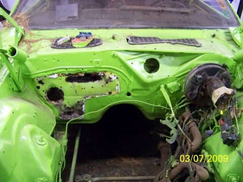 1974 Dodge Challenger - The engine bay of a car shows significant rust and exposed wiring, with a date stamp of 03/07/2009.