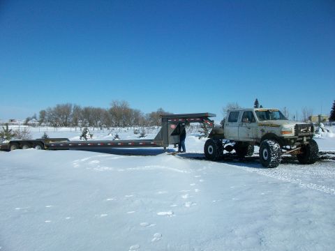 1992 Ford F-350 - Modified 1992 Ford F-350 pickup truck is hitched to a large gooseneck trailer in a snowy outdoor setting.