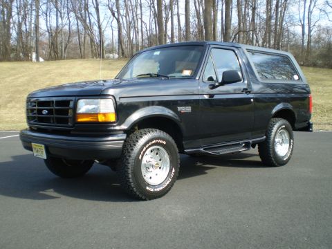 1996 Ford Bronco - This black 1996 Ford Bronco is shown from a 3/4 front angle, aftermarket wheels and running boards.