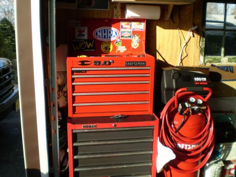 1981 Garelli Rally Sport - A collection of toolboxes and an air compressor are stored in a garage.