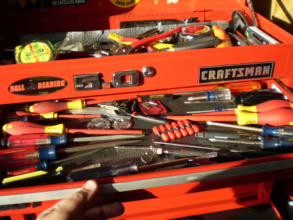 Red Craftsman tool box drawer of screwdrivers with a chrome 5.0 badge on the front