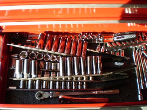 1981 Garelli Rally Sport - A collection of sockets and a ratchet are neatly organized in a red toolbox drawer.