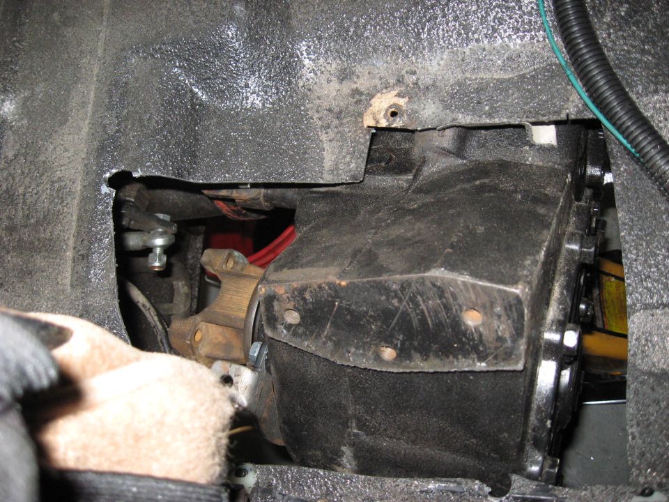 Close-up of a vehicle's transmission housing and linkage