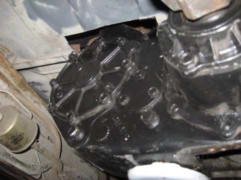 1991 Ford Bronco - Underside view of a vehicle's transfer case and filter.